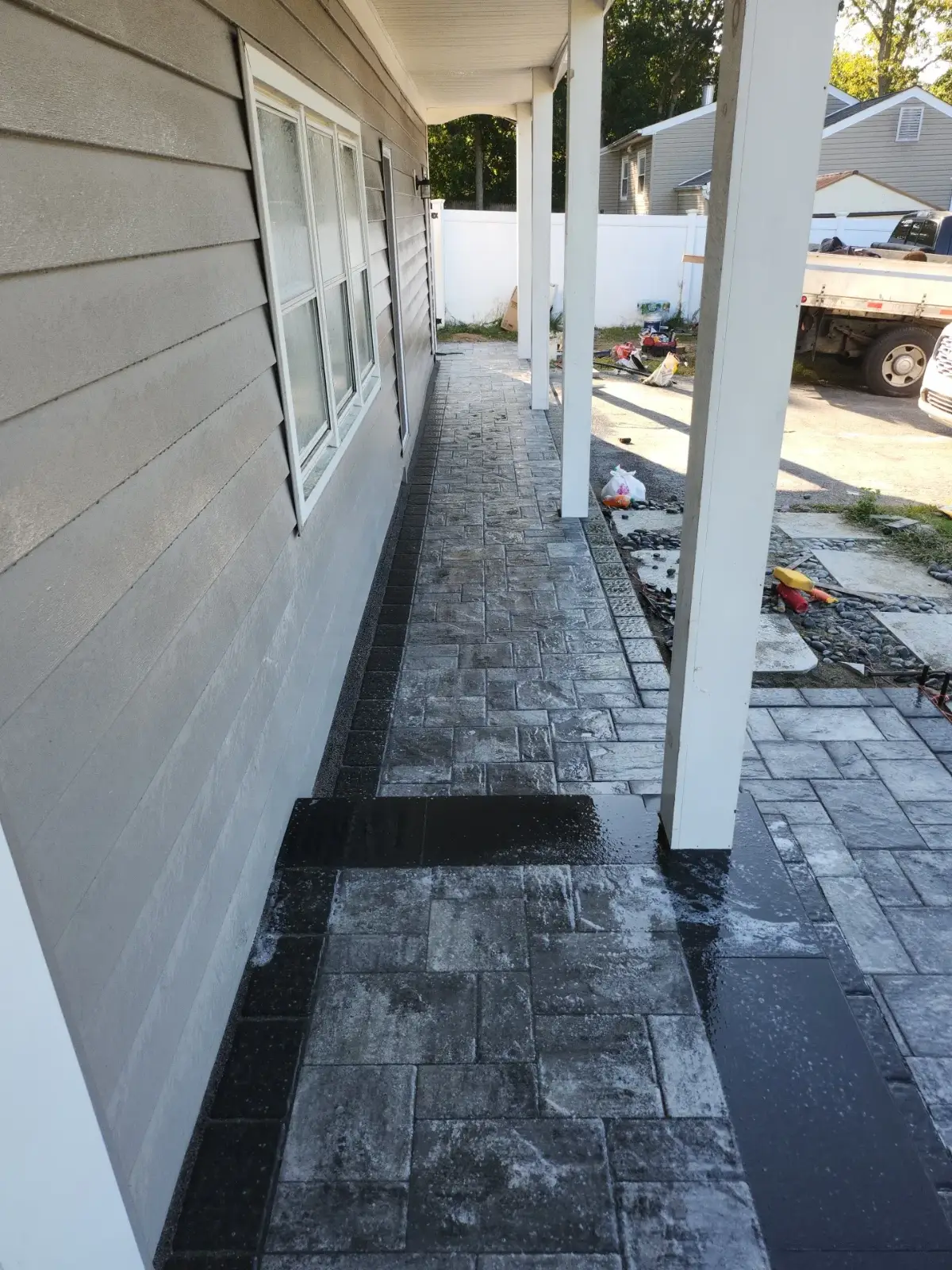 Covered-porch paver walkway by Promaster Maintenance Corp, Long Island, NY