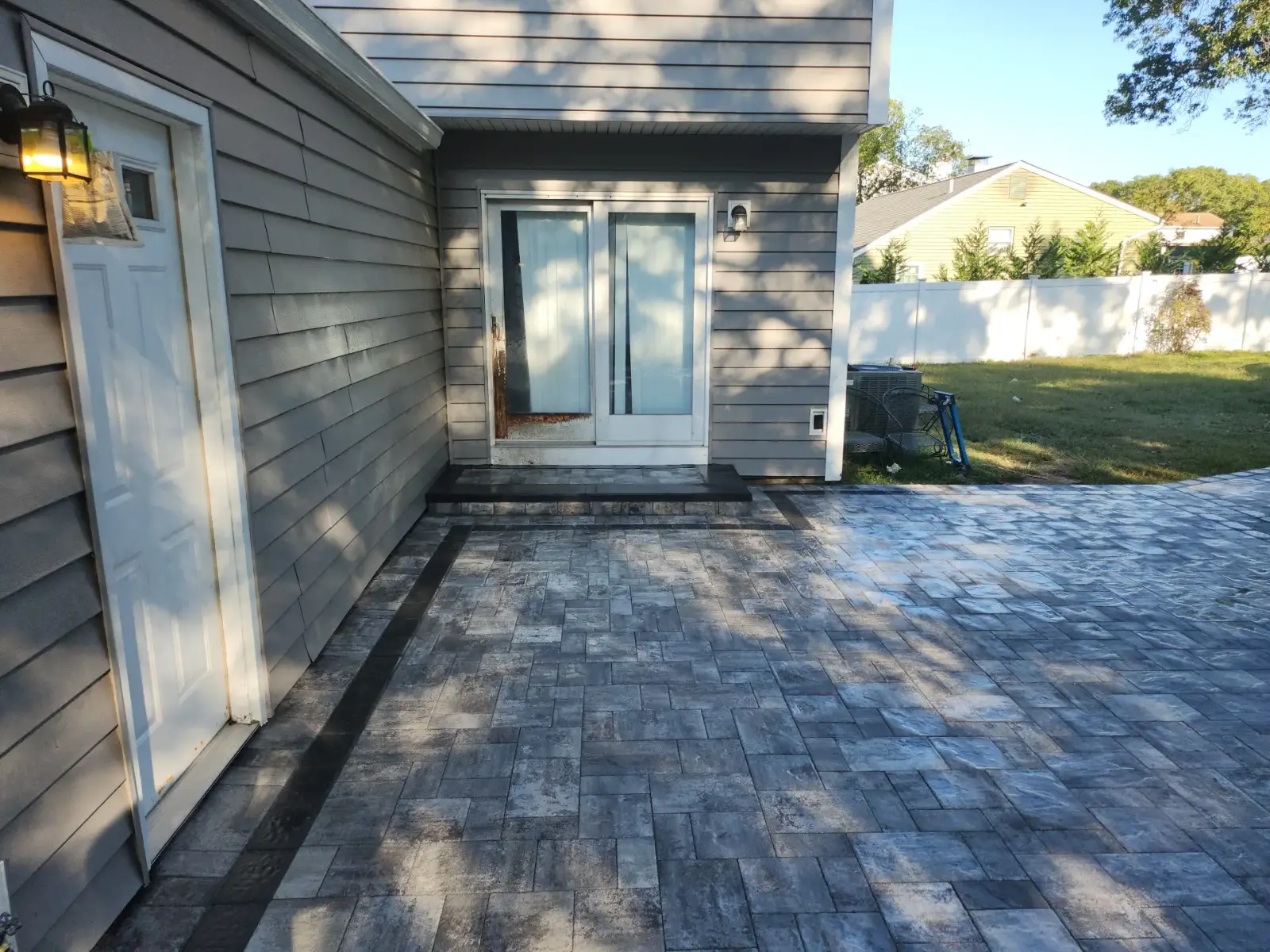 Paver patio with charcoal border by Promaster Maintenance Corp, Long Island, NY