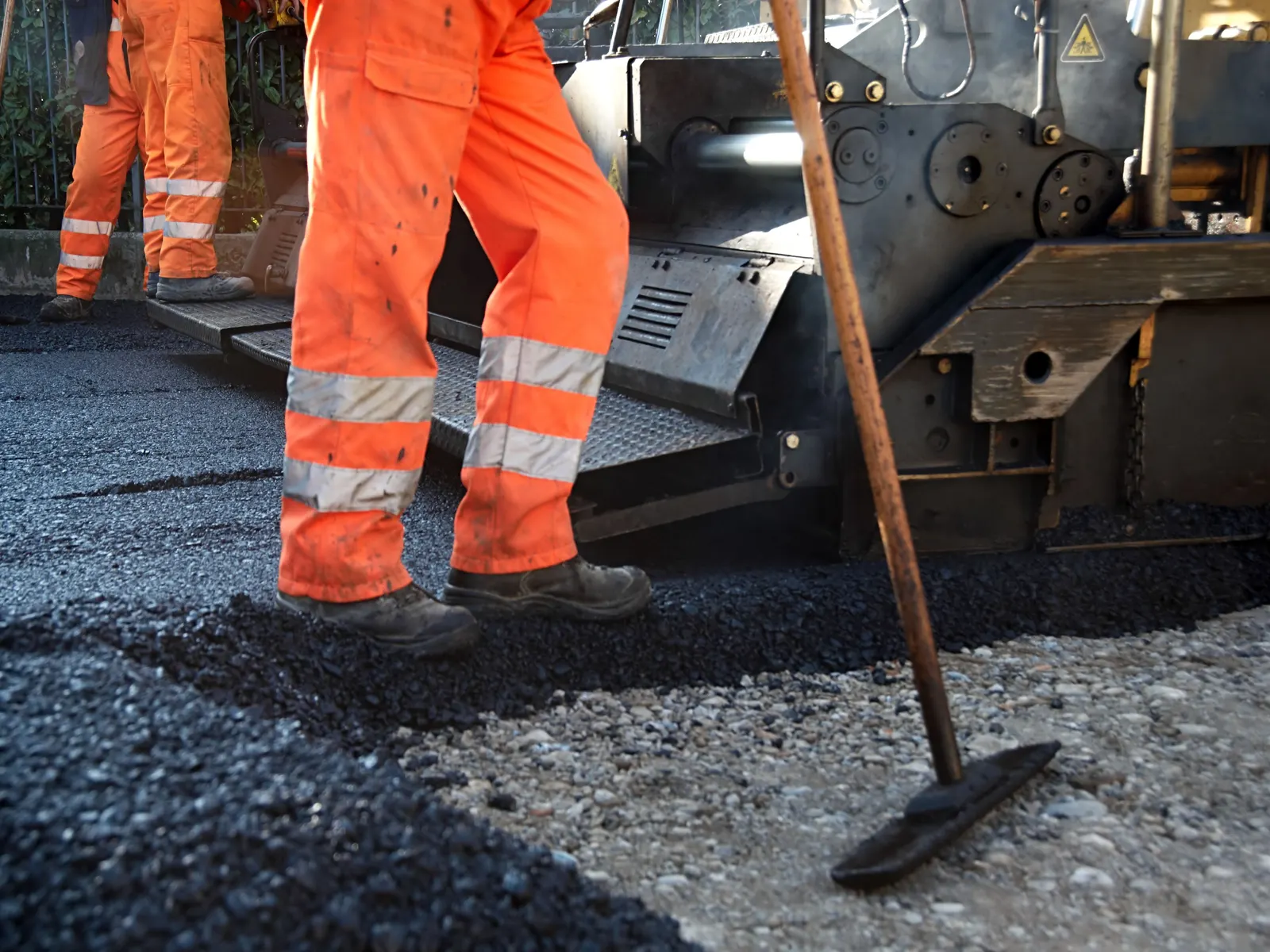 Asphalt paver laying a new course