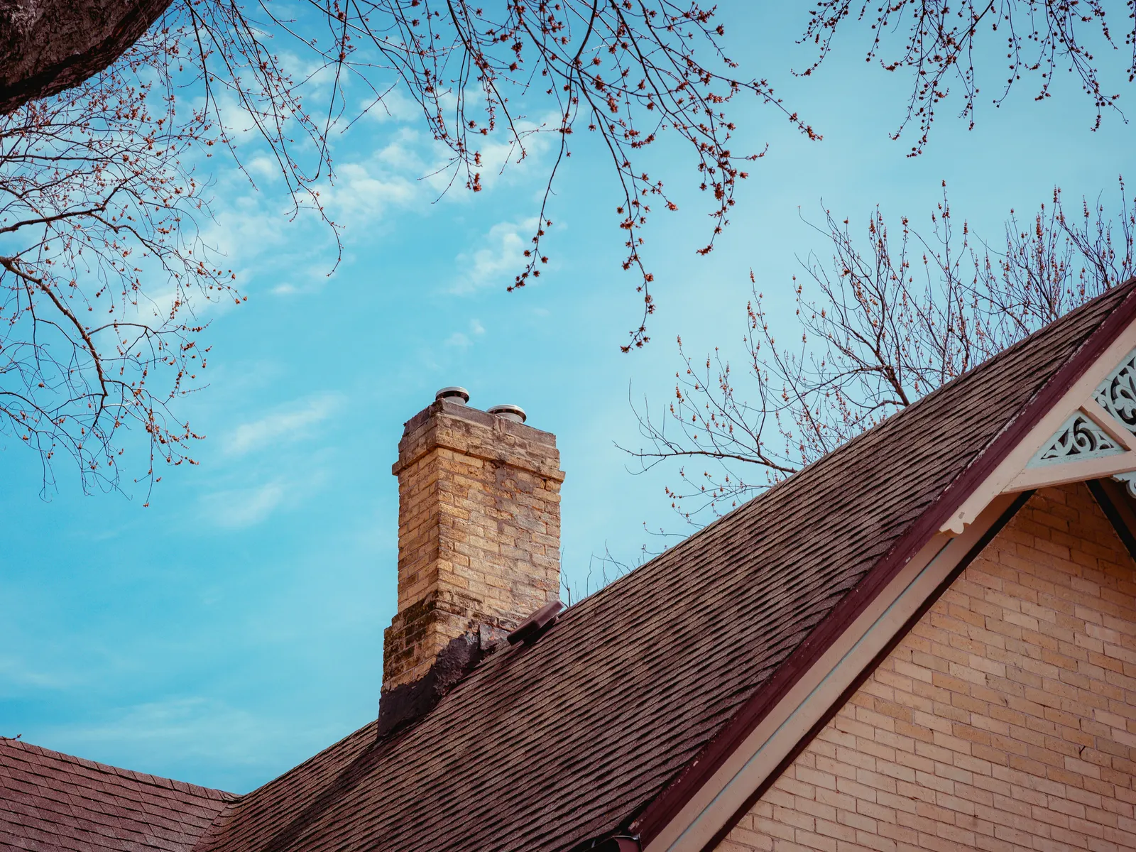 Brick chimney above a shingle-roofed gable