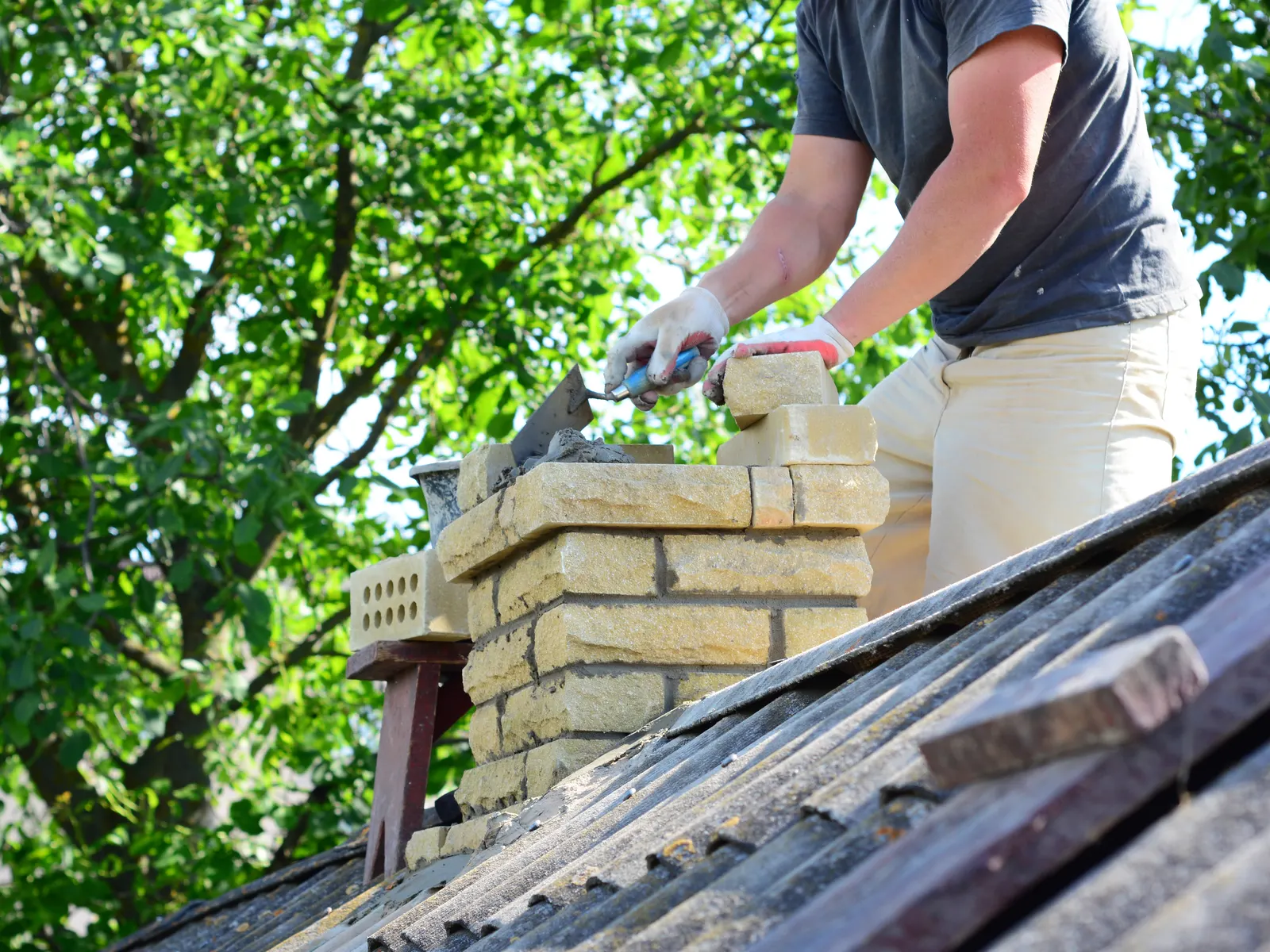 Chimney crown being rebuilt brick by brick