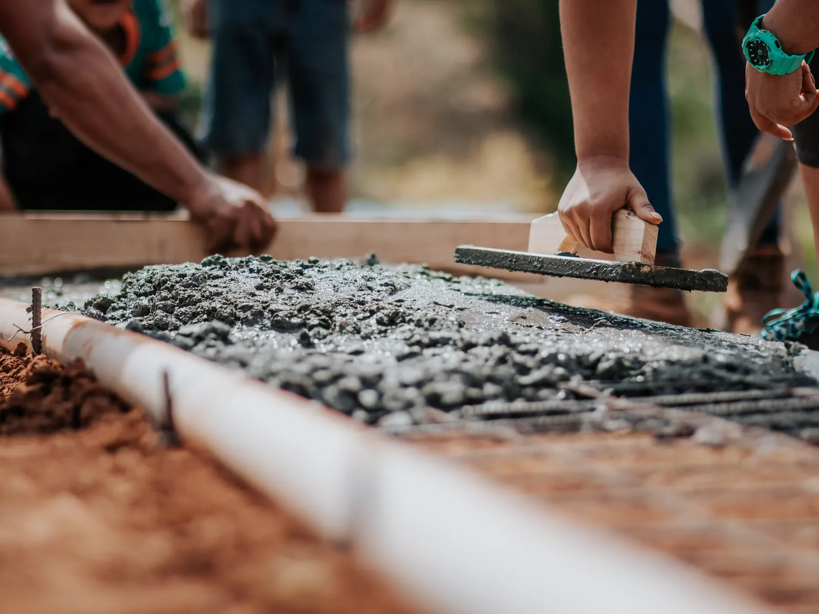 Screeding concrete level between forms