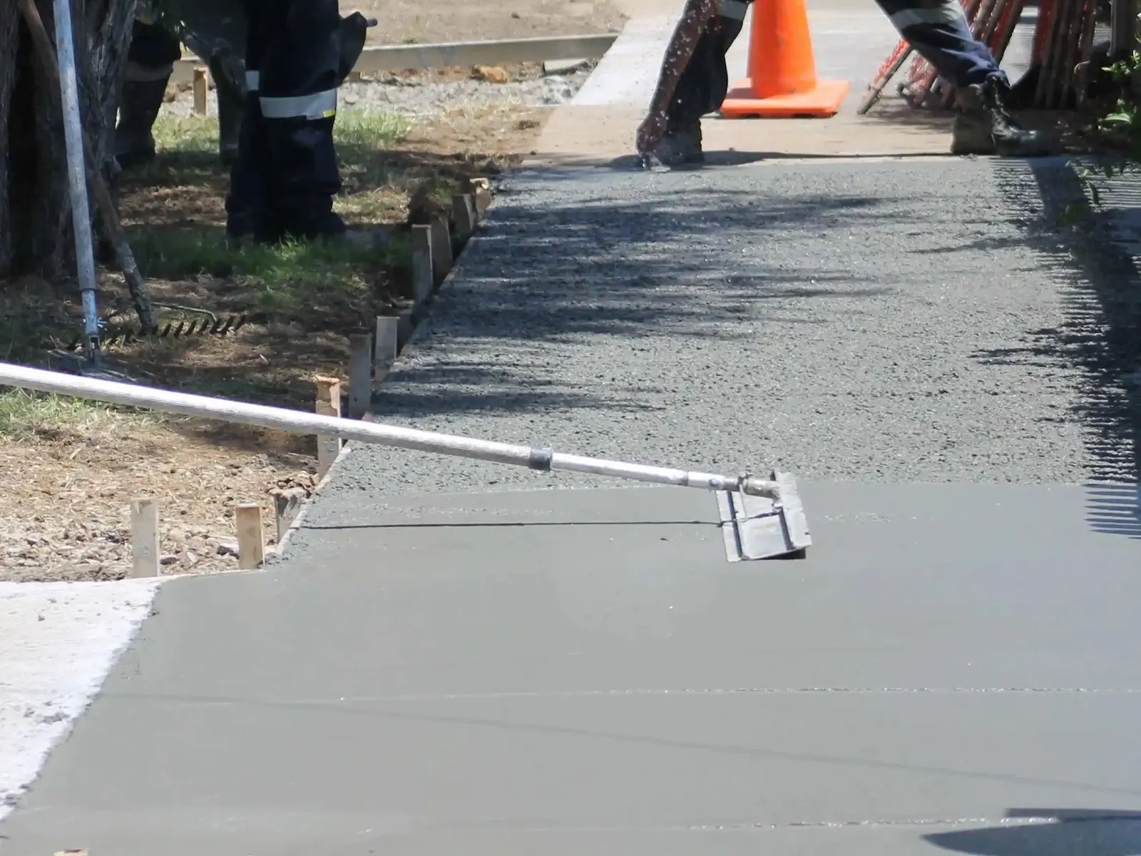 New concrete sidewalk being screeded