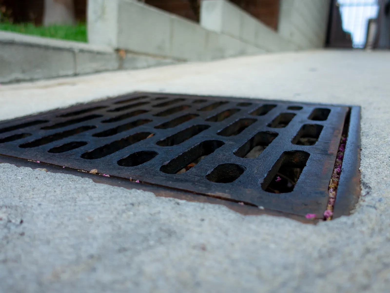 Catch basin grate set in concrete