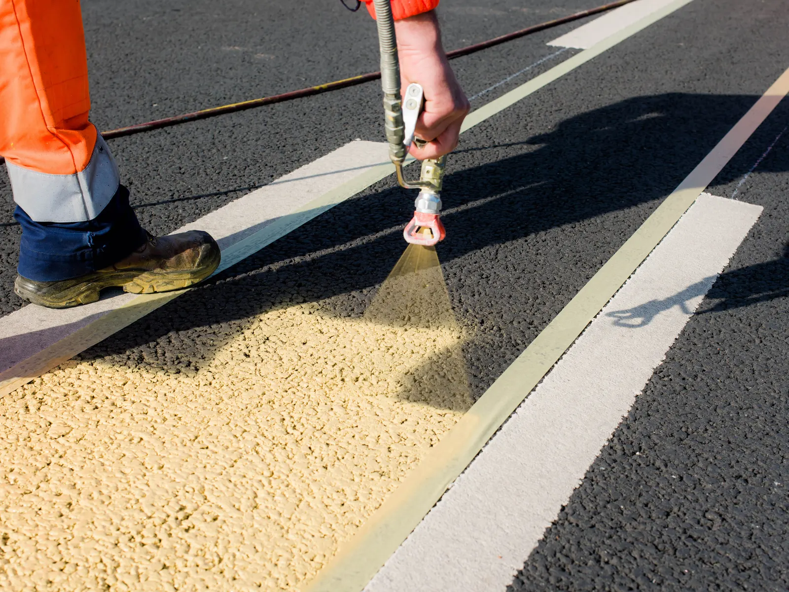Parking lot lines being sprayed by hand