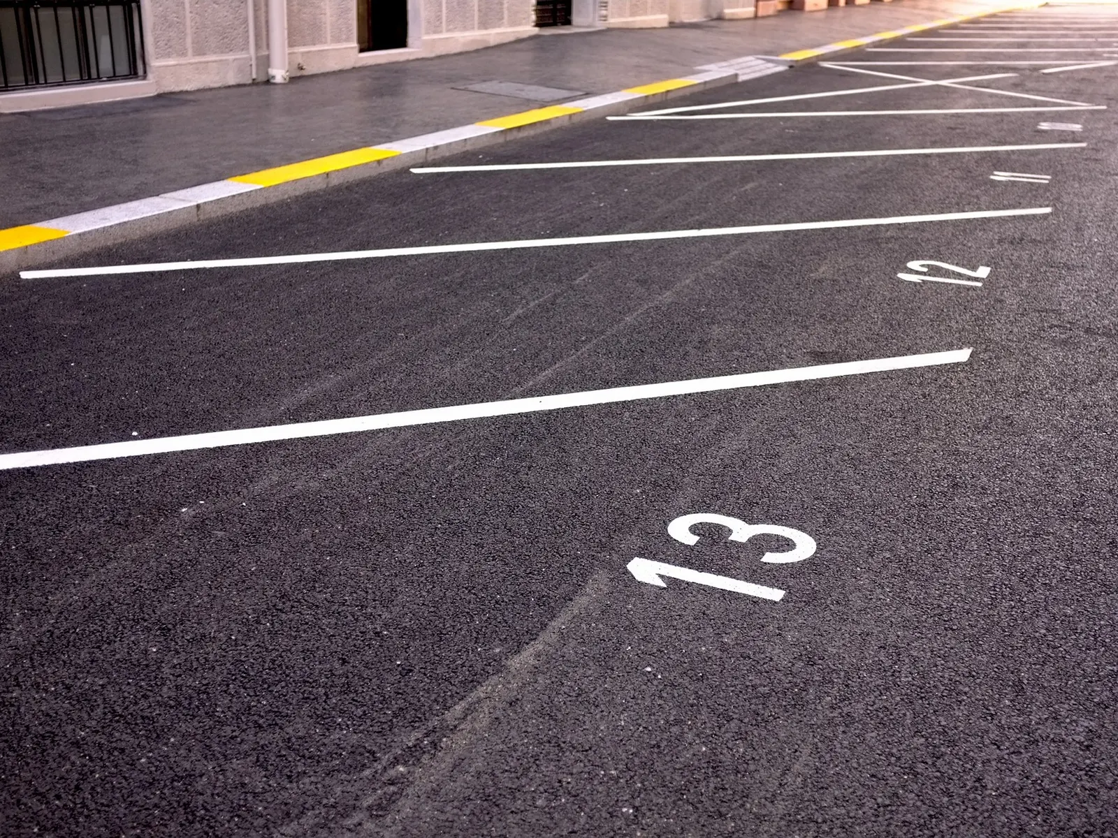 Numbered parking bays on fresh asphalt