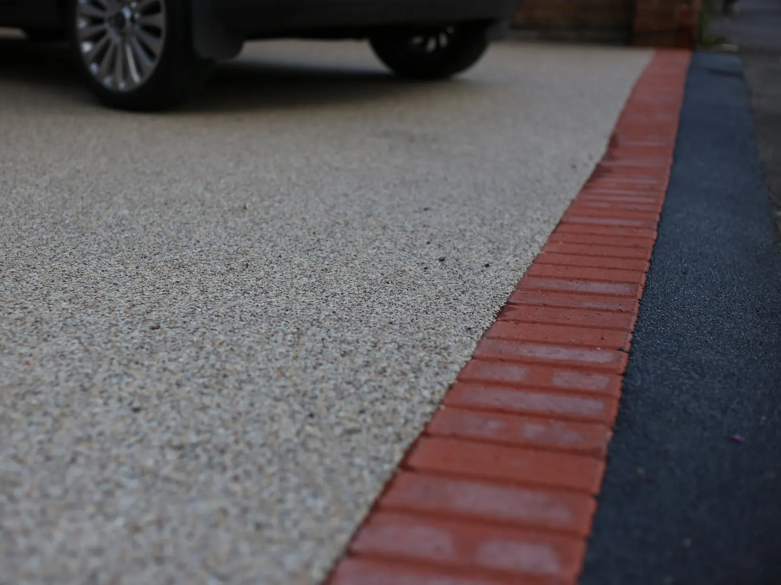 Resin bound driveway with a brick border